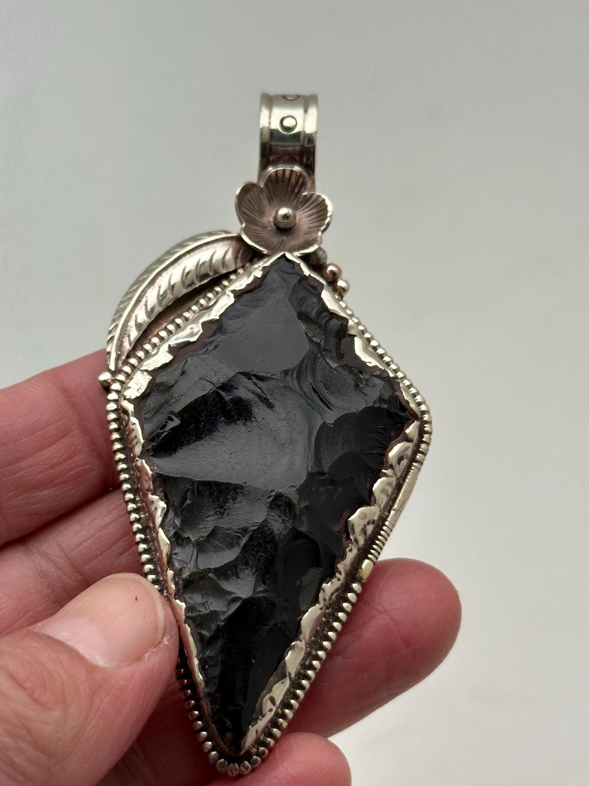 Obsidian Arrowhead pendant, handcrafted, Tibetan silver, floral design, Himalayan, Nepalese