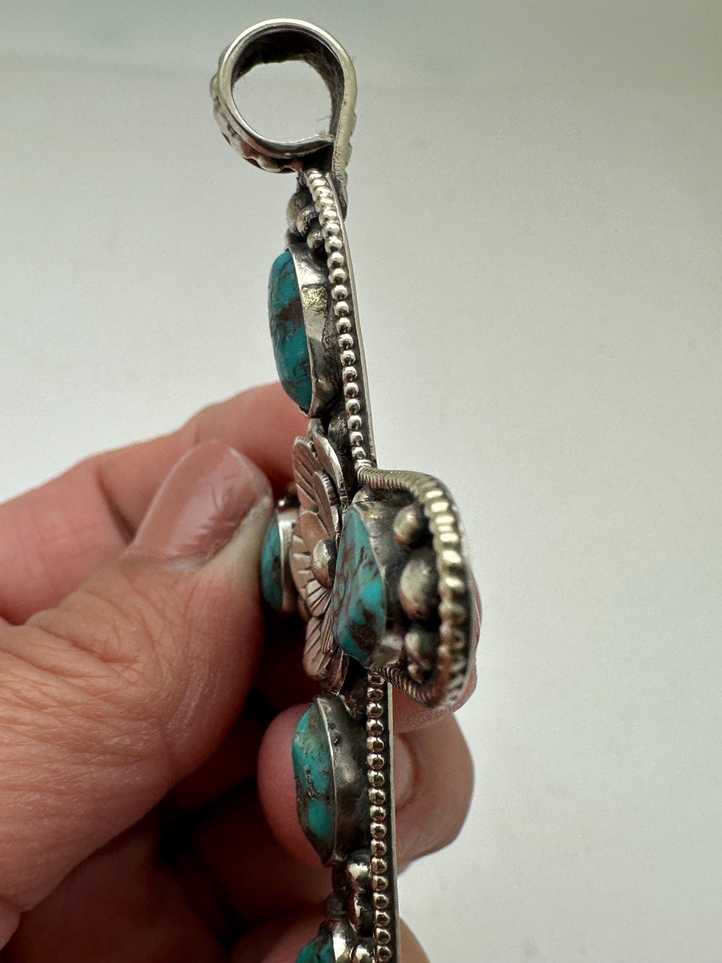 Handcrafted Tibetan Repousse Silver Cross Pendant with Turquoise, Floral Design